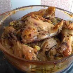 Chicken Legs in a Glass Cook Pot with Onions