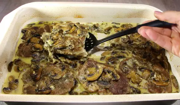Steaks in the Oven with Processed Cheese and Mushrooms