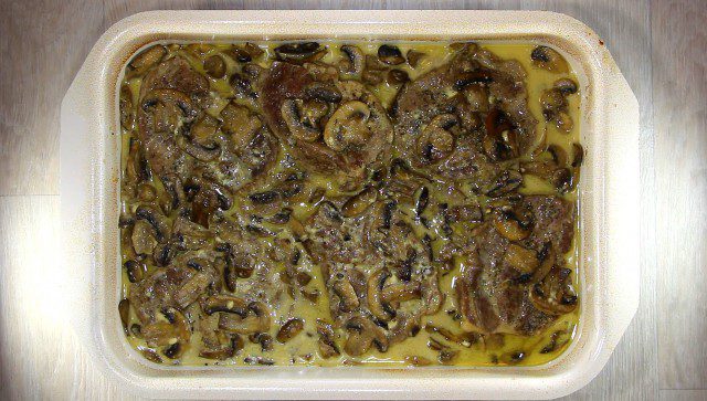 Steaks in the Oven with Processed Cheese and Mushrooms